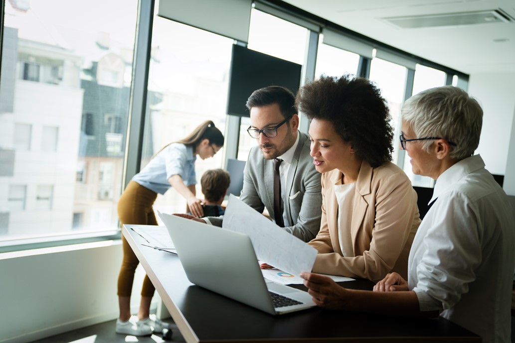 Diverse administrators focussed and concentrating on printed reports