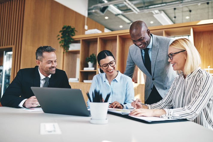 Four diverse administrators discussing about seamless timesheet approval workflow for managers, administrators, and employees