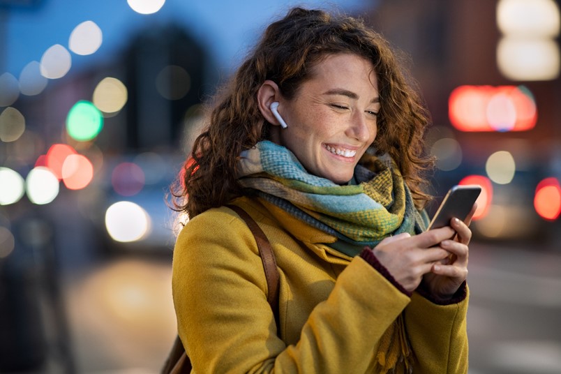 Smiling woman using a phone to access OfficeSeries services outside the office