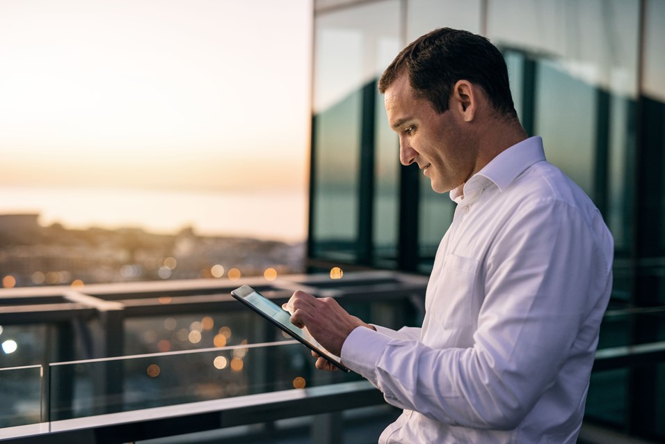 A man easily entering his timesheet on the go using a tablet