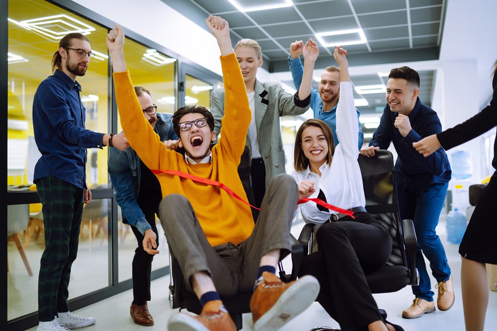 Workers having fun in an office cheering each other