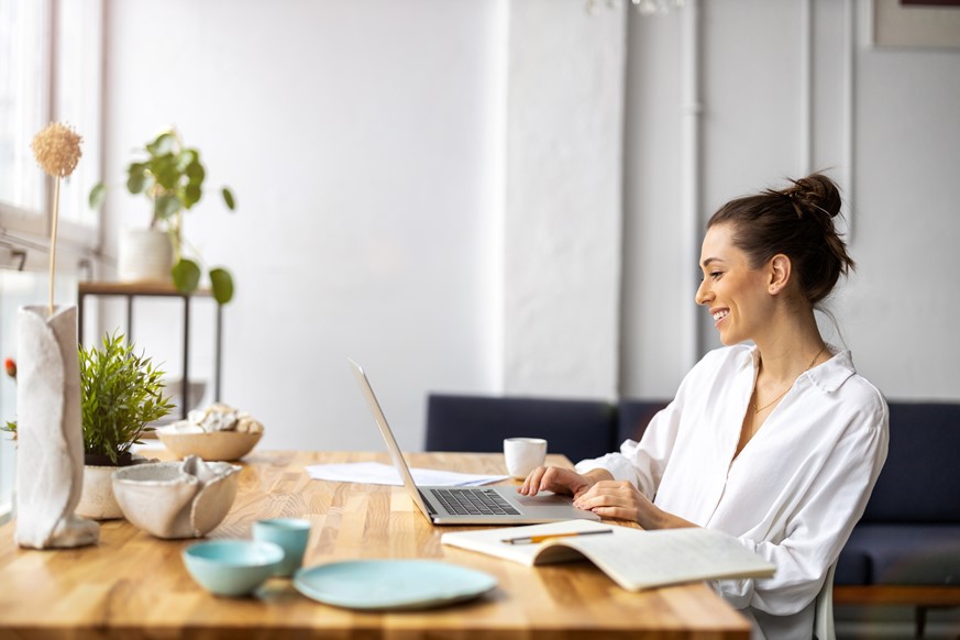 Woman with a laptop managing projects and tasks