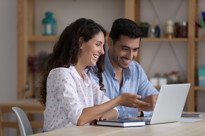 Happy business owners approving timesheet for the employees